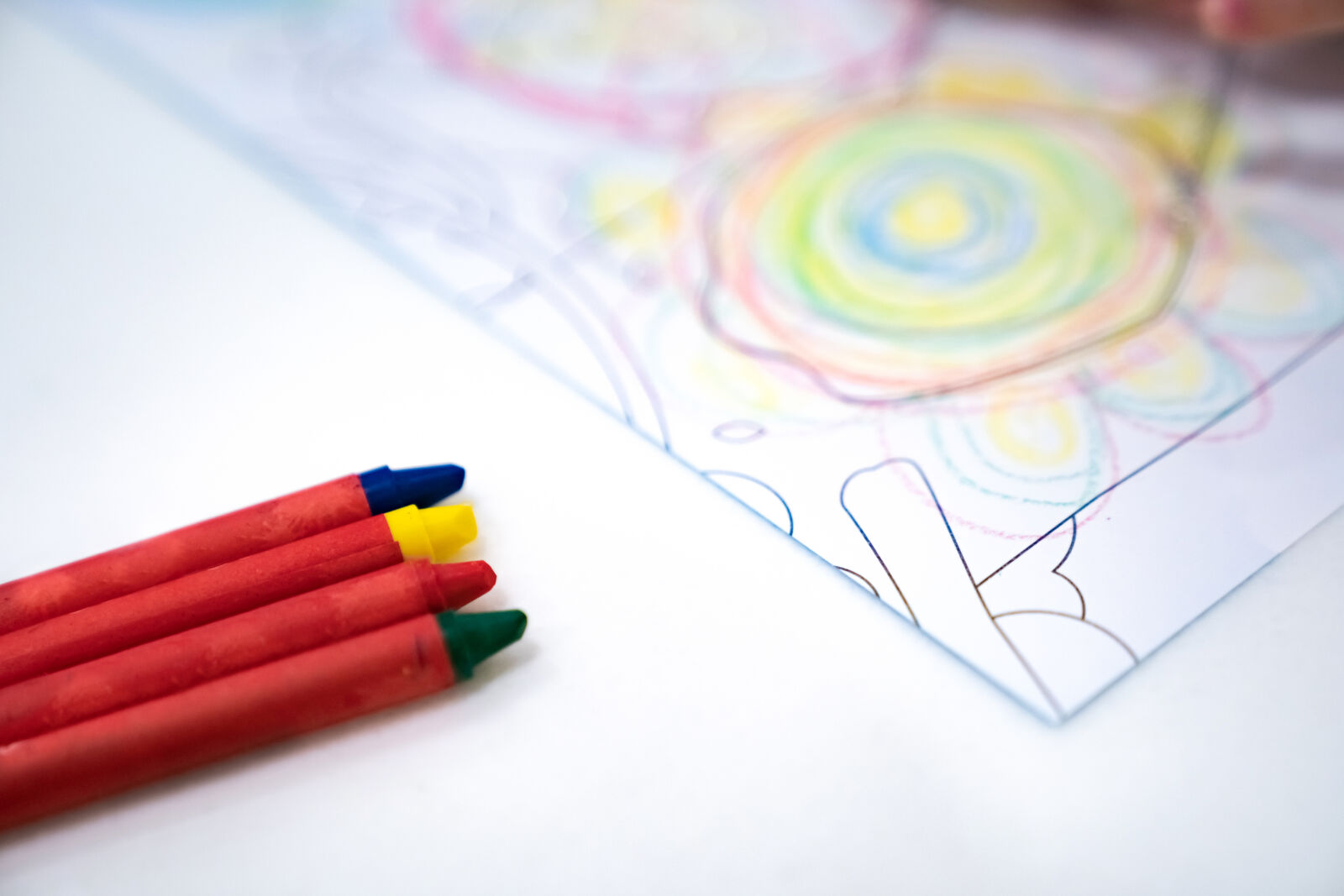 little girl plays and learns to coloring Crayon on the paper in the ice-cream restaurant., Bangkok, Thailand.